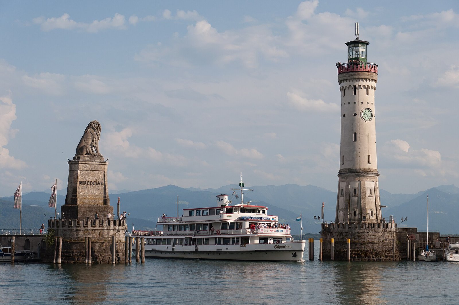 Harbor entrance with Bavarian Lion, the New Lighthouse and the Schwaben in Lindau (Lake Constance, Germany)